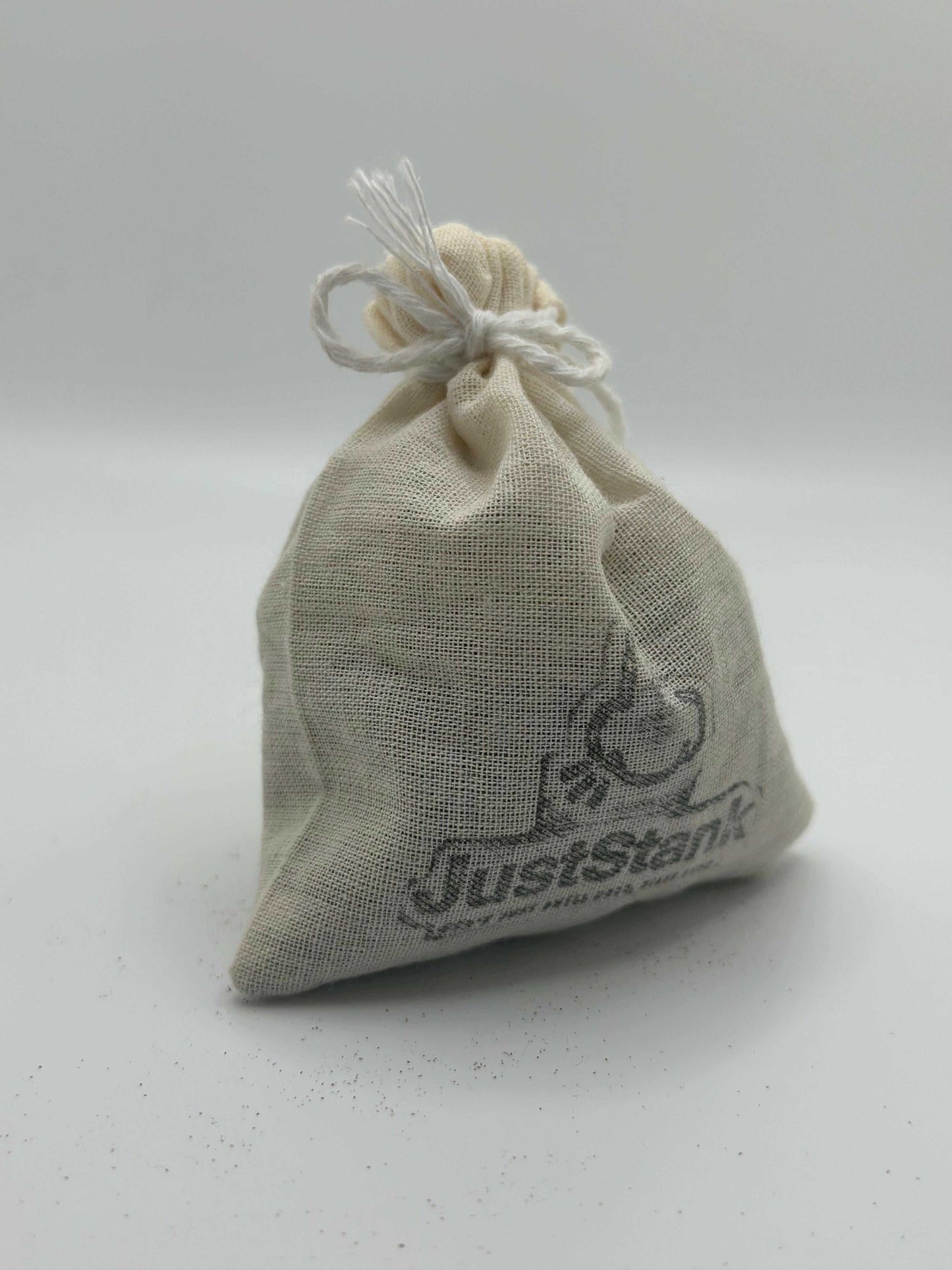 Natural linen pouch containing Grass Air Freshener by JustStank with fresh cut grass scent